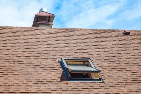 dreamstime_m_106308510 New roof with skylight, asphalt roofing shingles and chimney.
